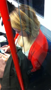 Downblouse of a nice girl sitting in a public train