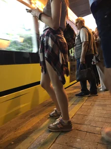 Cute Teen in Shorts on the Tram Stop