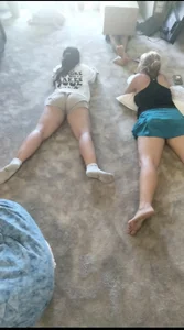 Two Chubby Teens in Shorts Lying on the Floor Carpet
