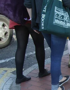 Girl in a pink skirt and stockings accidentally showing some cheek
