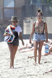 Ashley Tisdale in cheetah print swimsuit on the beach in Malibu