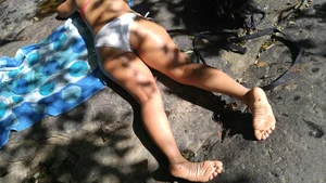 Sexy bikini ass laying out on the rocks up close