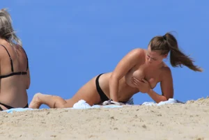 Sexy girls topless on a nude beach showing their nice tits