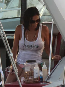 Bikini babe on a boat with a wet see through white shirt showing her tits