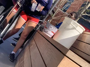 Bunch of girls in various outfits at a Cardinals baseball game