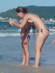 Milf on the beach in a thong bikini