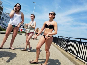 Cute brunette looking sexy in black bikini with friends