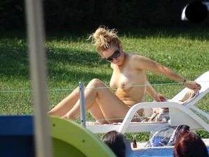 Topless lady at the pool with nice tits