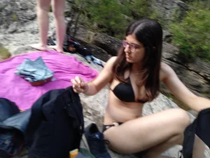 Sexy girl with glasses in a black bikini up close