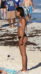 Tattooed beach babe in black thong with a nice ass
