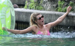 Blonde bikini girl at the pool in pink bikini top with amazing tits