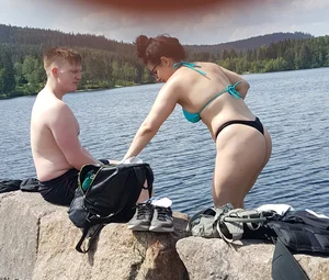 Thick brunette at the lake in a black thong bikini