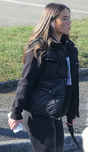 Pouting brunette teen in black leggings