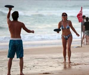 Older lady playing on the beach in her bikini