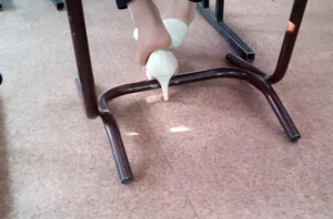 Feet in Pantyhose With High-Heeled Shoes Taken Off Under Desk Creepshot