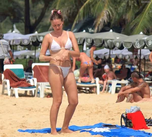 Sexy beach babe in see through wet white thong bikini