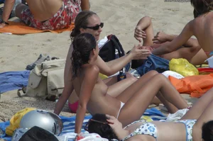 Topless girls on a beach in Barcelona