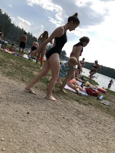Cute Barefoot Girl in a Black Body Swimsuit Walking on a Road