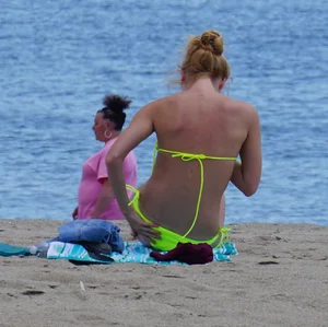 Sexy ass blonde milf on the beach in a thong with cameltoe and bending over