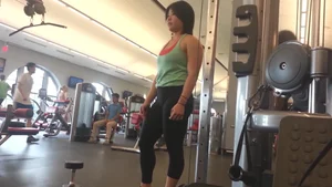 Buff Asian chick working out at the gym in leggings