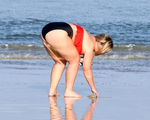 Thick BBW blonde lady in a bikini at the beach