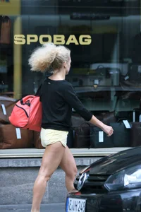 Blonde looking sexy walking in short yellow shorts