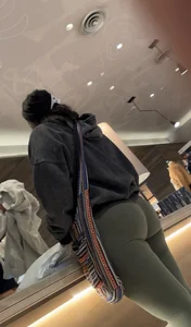 Sexy bubble butt in tight green leggings at the mall