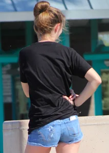 Candid skinny college girl in denim shorts showing some cheeks