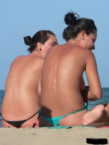 Bunch of sexy babes on the beach topless and in thong bikinis