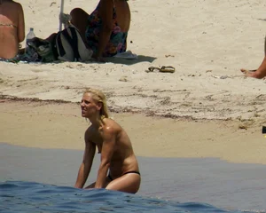 Small boobed topless milf on the beach