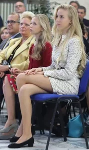 An Extremely Cute Blonde Teen in a Short Dress Sitting With Her Slim Legs Crossed