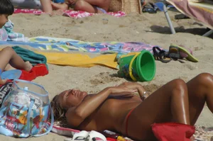 Topless girls on a beach in Barcelona