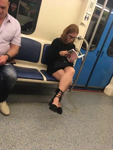 Girl in a Dress Reading a Book in Subway Train Candid