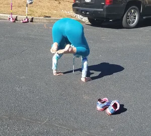 Girl in Blue Tights Doing a Handstand Candid Photo