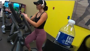 Smoking hot brunette working out at the gym in tight leggings