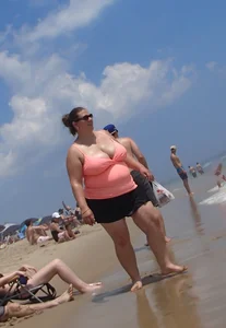 Thick lady on the beach with huge tits