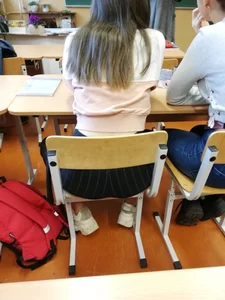 College candid girl in tight pants sitting at her desk in class creepshot