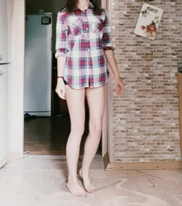 Young Skinny Girl in a Shirt And Panties Entering a Room With Bare Feet, Home Photo