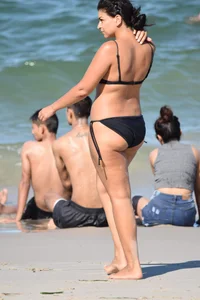 Thick mature brunette bikini lady on the beach with a nice body