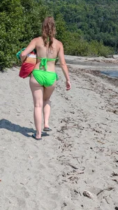 Beautiful Brown hair tight Girl in green bikini on the beach. oc