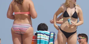 Two thick white girls in bikinis on the beach with big asses