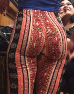 Big fat ass in pattern flare pants with some pokey pierced nipples in a blue crop top