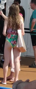 Skinny girl in a one-piece swimsuit by the pool