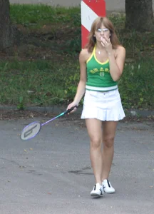 Pretty girl playing tennis in a skirt and walking in jeans