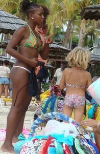 Sexy black babe in various bikinis on the beach while on vacation