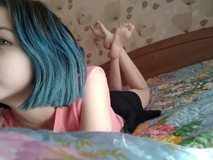 Girl with Blue Hair Lying in Bed with Cute Bare Feet Selfie