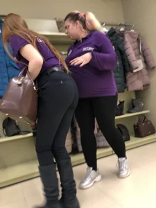 Cute candid shop assistant wearing boots and tight pants