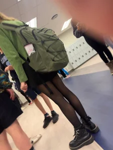College teen in black pantyhose in the hallway, slim legs