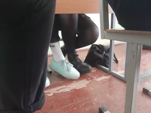 Legs of candid college teens wearing pantyhose in class