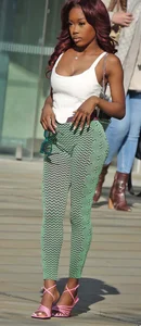 Slim ebony teens in leggings posing in the sun